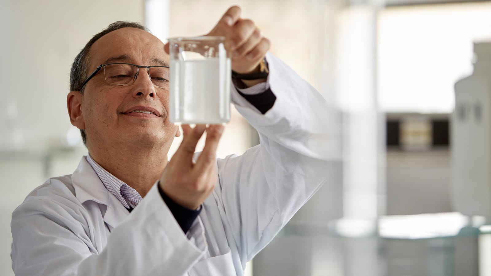 A laboratory technician assesses a sample of anti-microbial jerry can cleaning solution
